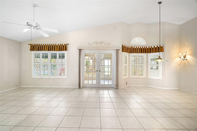 tiled spare room with vaulted ceiling, french doors, and ceiling fan