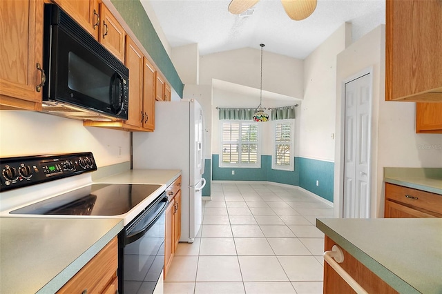 kitchen with ceiling fan, hanging light fixtures, black appliances, light tile patterned flooring, and vaulted ceiling