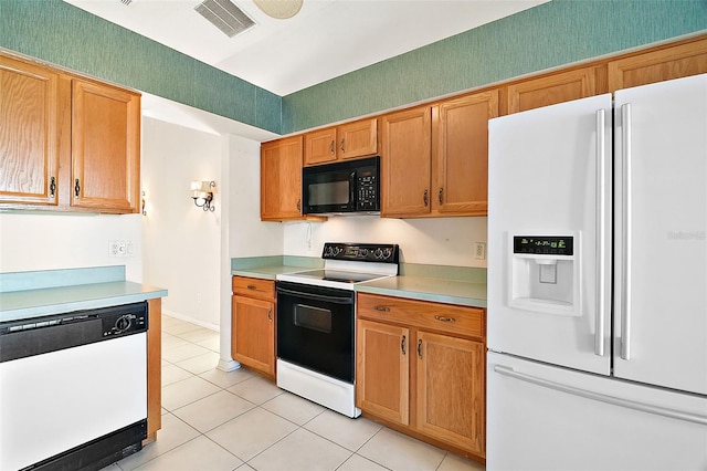 kitchen featuring white appliances and light tile patterned flooring