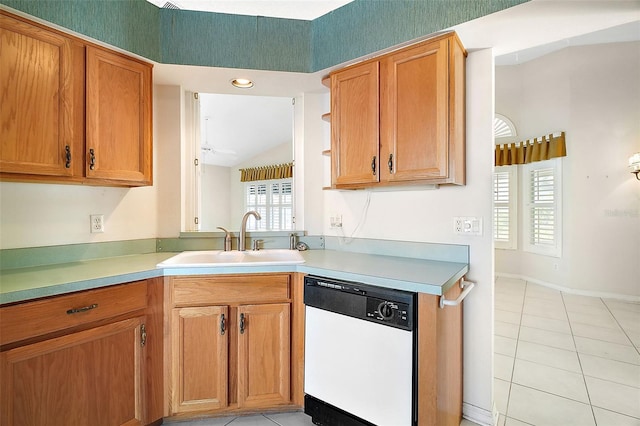 kitchen with white dishwasher, sink, a healthy amount of sunlight, and light tile patterned flooring