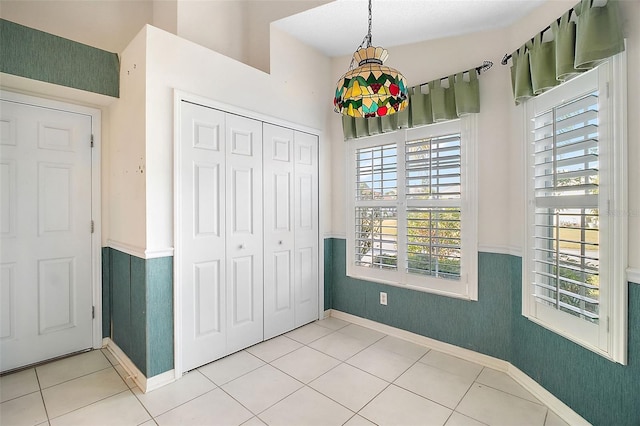 tiled bedroom featuring a closet