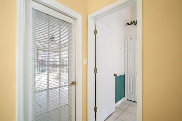 corridor featuring light tile patterned floors