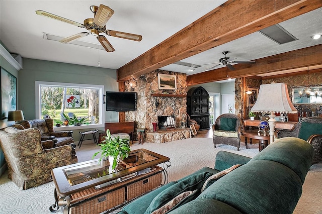 carpeted living room with a fireplace, beam ceiling, and a wealth of natural light