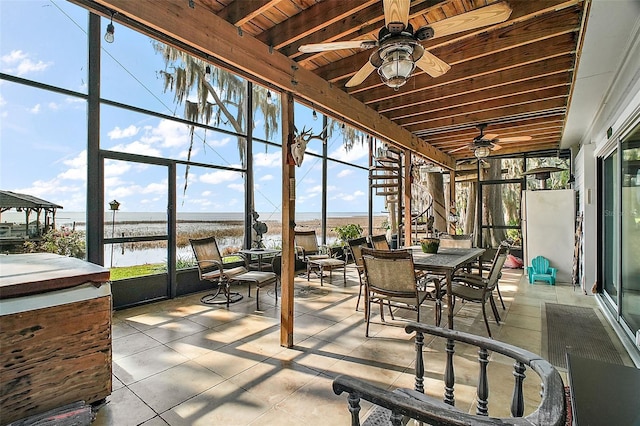 sunroom with beam ceiling, a water view, wooden ceiling, and ceiling fan