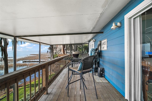wooden deck featuring a water view