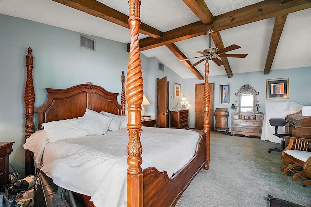 bedroom with lofted ceiling with beams, ceiling fan, carpet floors, and a textured ceiling