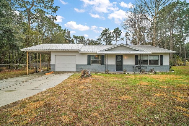 ranch-style home featuring a garage, a carport, and a front yard