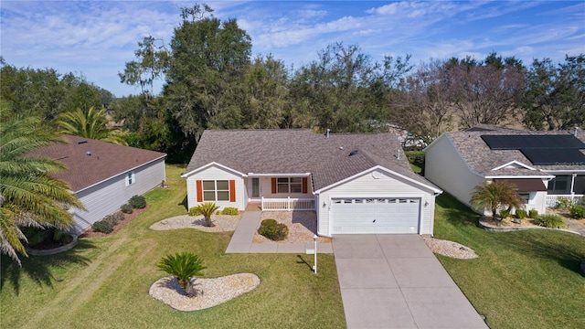 single story home with a porch, a garage, and a front yard