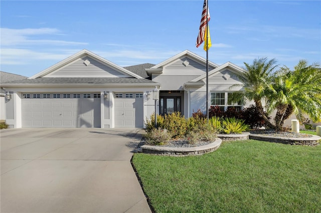 single story home with a garage and a front lawn