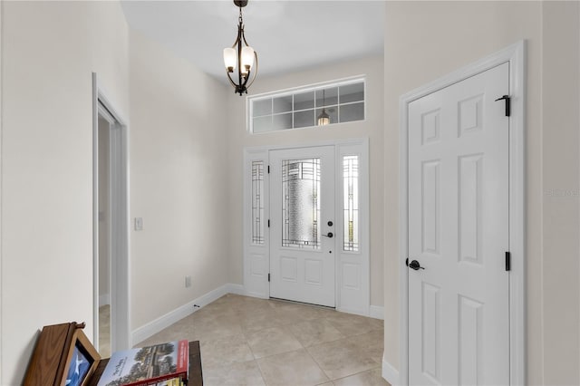 foyer with light tile patterned floors and a chandelier