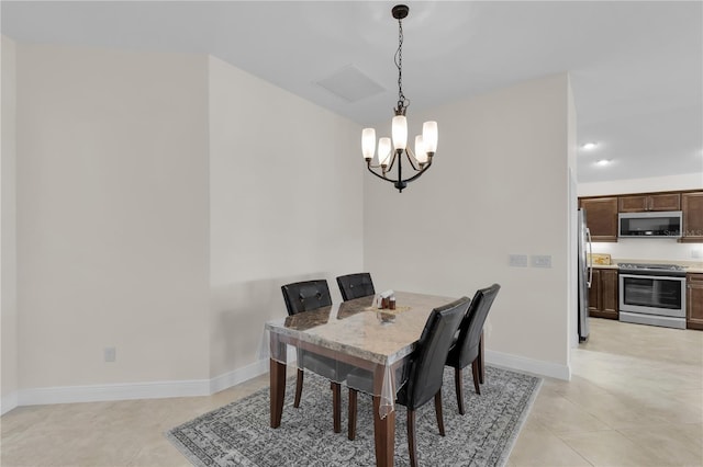 tiled dining area featuring an inviting chandelier