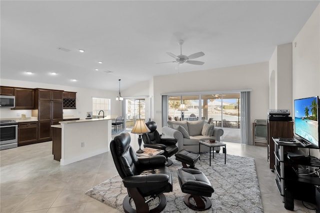 tiled living room with lofted ceiling, a wealth of natural light, and ceiling fan