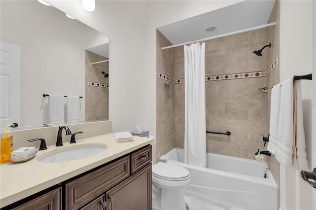 full bathroom with vanity, shower / tub combo with curtain, and toilet