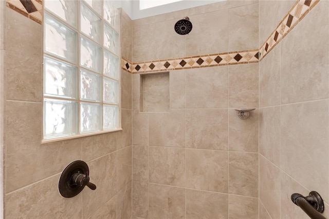 bathroom featuring tiled shower