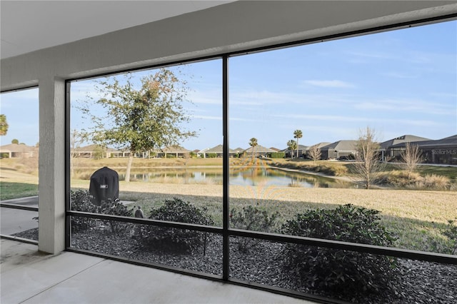 entryway with a water view and concrete floors