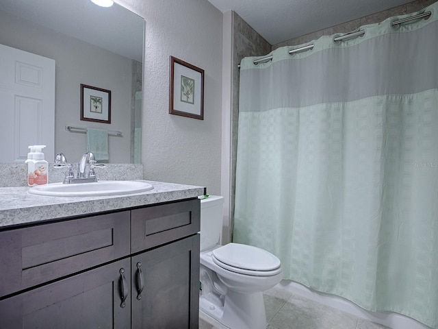 bathroom with tile patterned flooring, vanity, walk in shower, and toilet