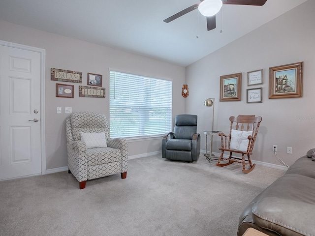 sitting room with light carpet, vaulted ceiling, and ceiling fan