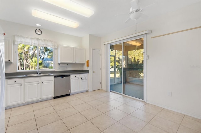kitchen featuring sink, light tile patterned floors, dishwasher, ceiling fan, and white cabinets