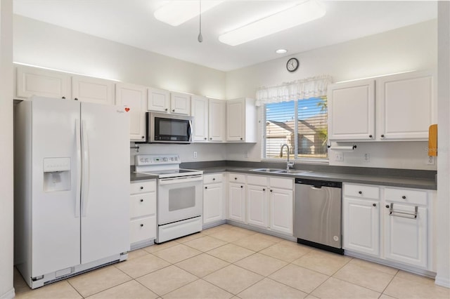 kitchen featuring white cabinetry, sink, light tile patterned flooring, and appliances with stainless steel finishes