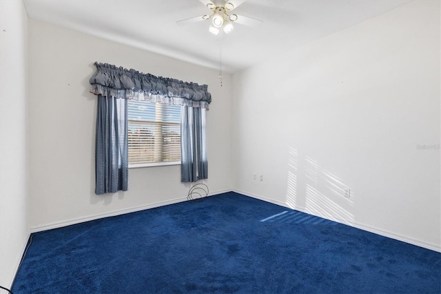carpeted spare room featuring ceiling fan