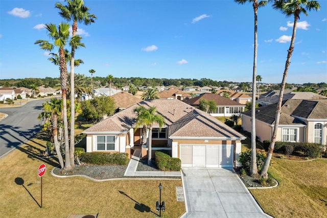 view of front of property with a garage and a front lawn