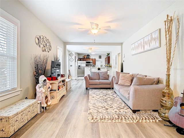 living room with hardwood / wood-style floors and ceiling fan