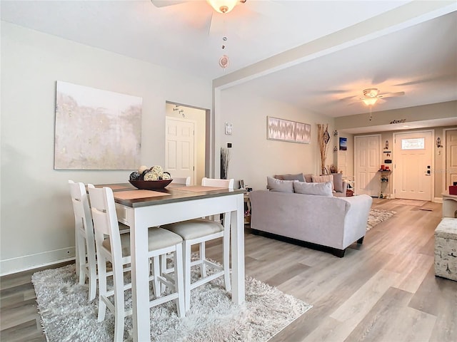 dining area featuring ceiling fan and light wood-type flooring