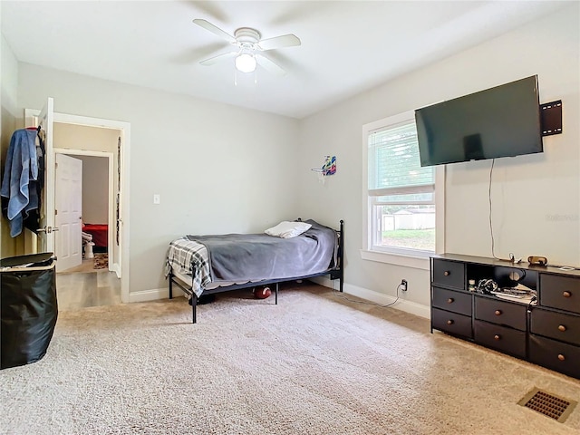 bedroom featuring light carpet and ceiling fan