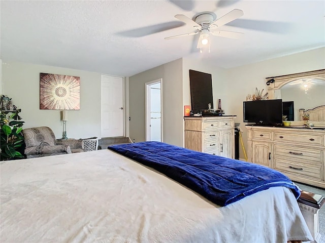 bedroom with a textured ceiling and ceiling fan