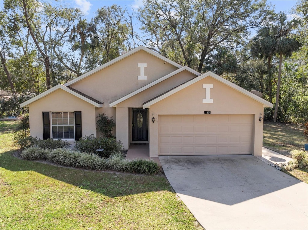 single story home featuring a garage and a front yard