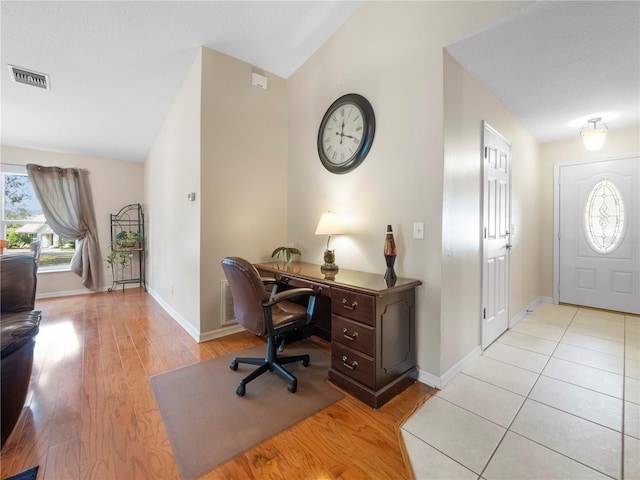 office area with vaulted ceiling and light hardwood / wood-style flooring