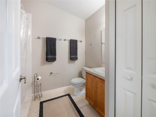 bathroom with vanity, tile patterned floors, a textured ceiling, and toilet