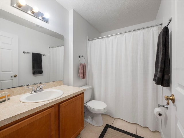 bathroom featuring vanity, tile patterned floors, toilet, and a textured ceiling