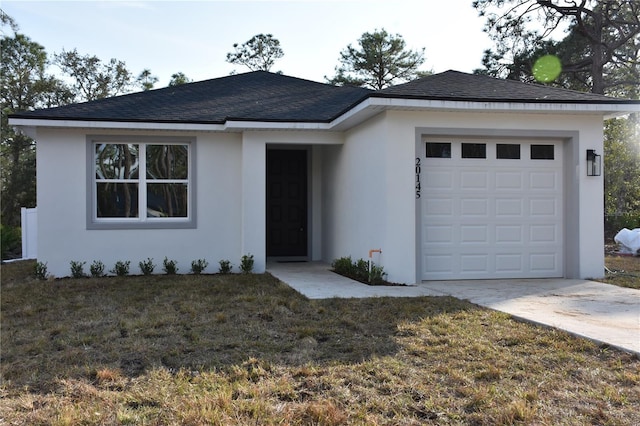 ranch-style home with a garage and a front yard