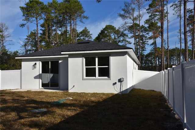 rear view of property with a lawn