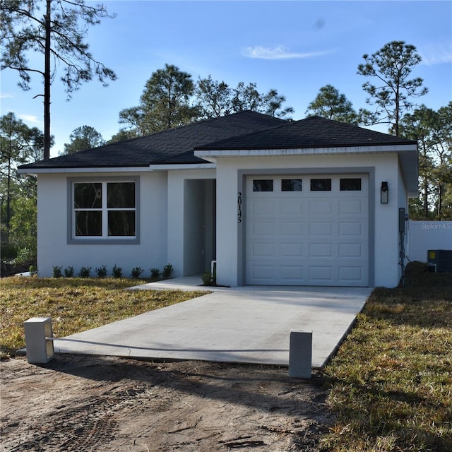 view of front of home featuring a garage and central air condition unit