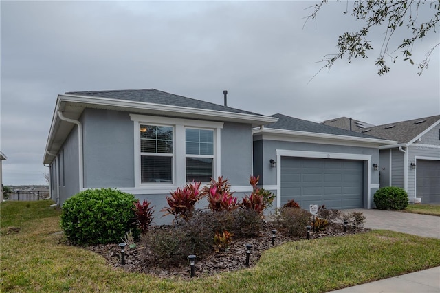 view of front of property with a garage and a front yard