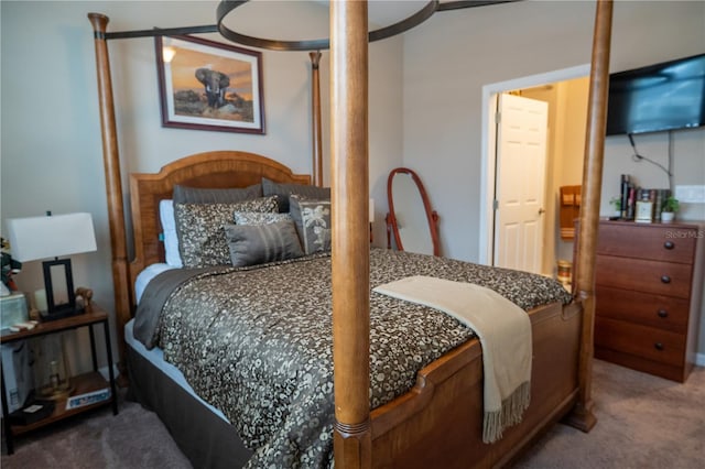 bedroom featuring connected bathroom and carpet flooring