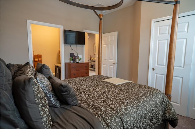 bedroom featuring ensuite bath and carpet flooring