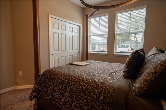 carpeted bedroom with multiple windows and a closet