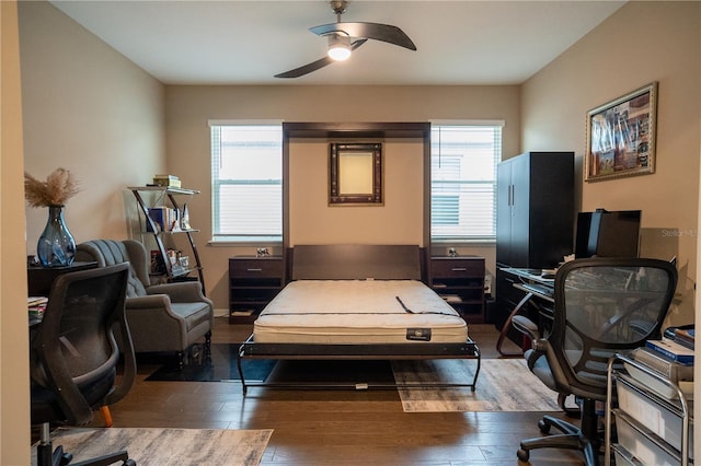 bedroom featuring ceiling fan and dark hardwood / wood-style floors