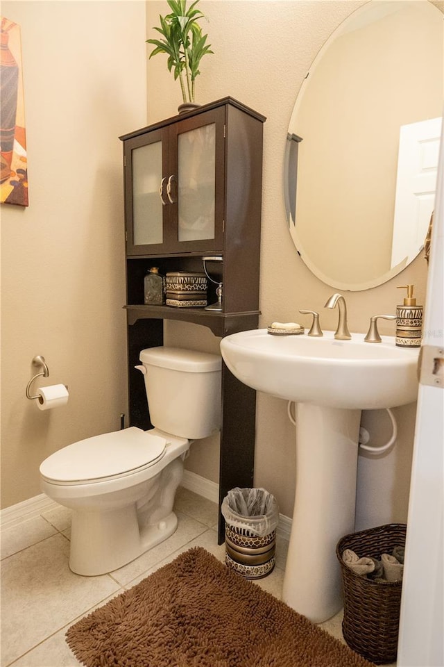 bathroom featuring tile patterned flooring and toilet