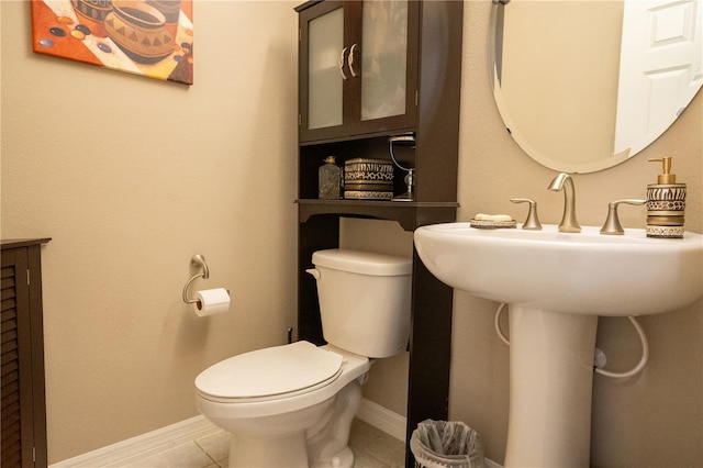 bathroom featuring toilet and tile patterned flooring