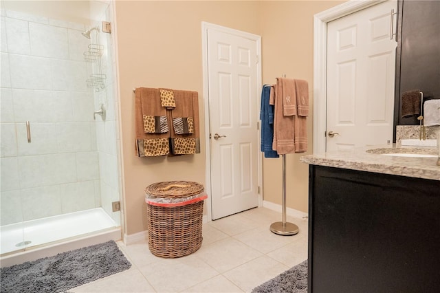 bathroom with tile patterned flooring, vanity, and a shower with door