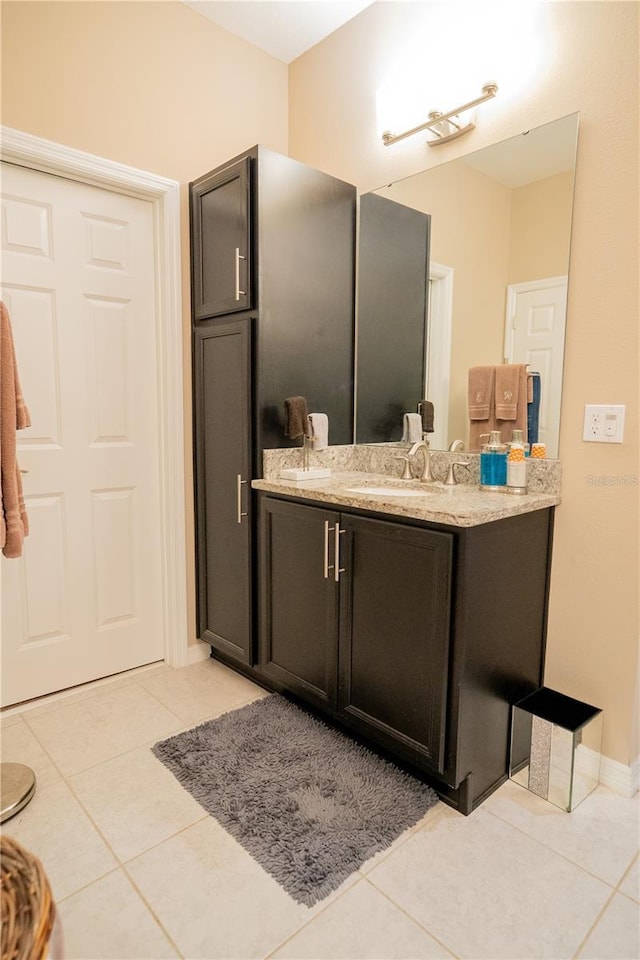 bathroom with tile patterned flooring and vanity