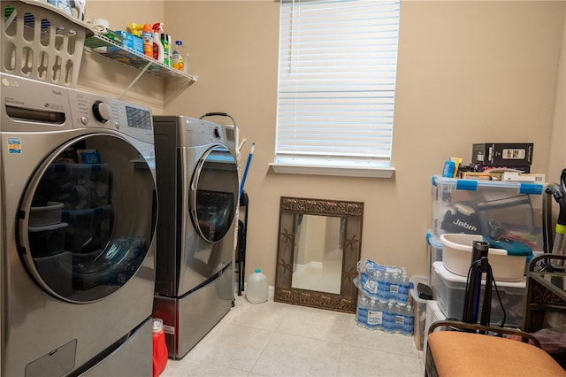 laundry area featuring light tile patterned floors and washer and dryer