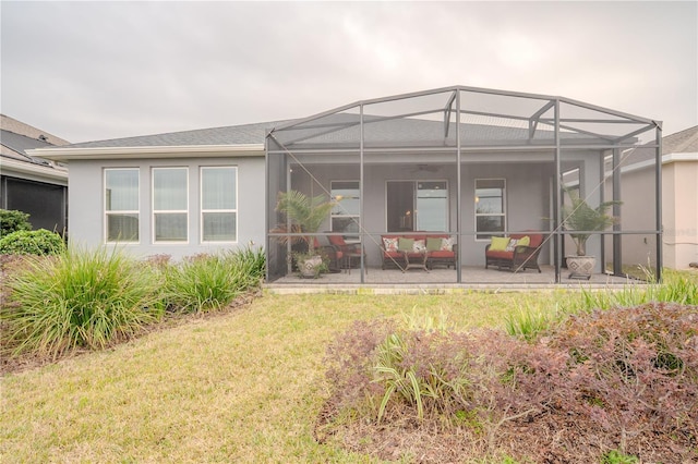 rear view of property featuring a lanai, a lawn, and a patio area