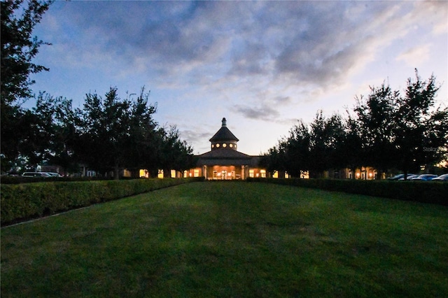 yard at dusk featuring a gazebo