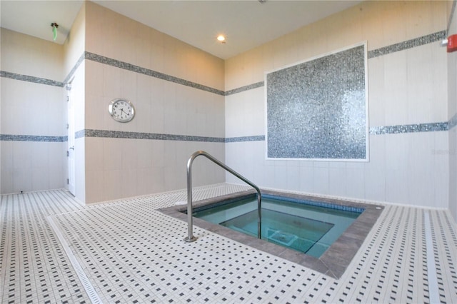 view of pool with an indoor hot tub