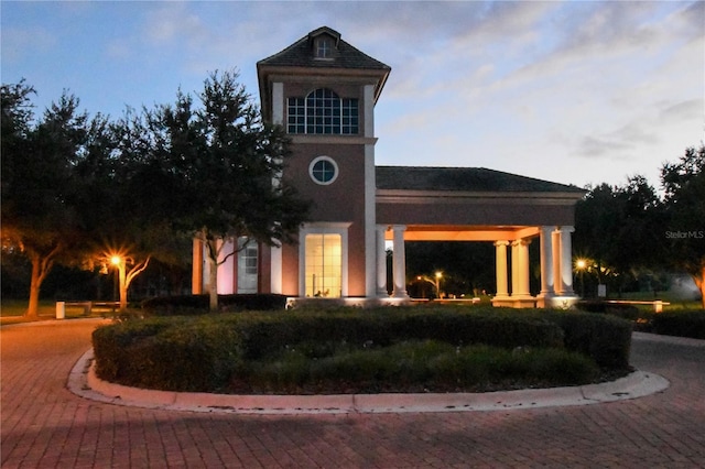 view of outdoor building at dusk